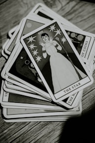 a stack of cards sitting on top of a wooden table