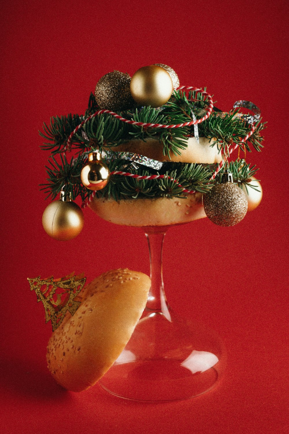 a wine glass filled with christmas decorations and a cookie