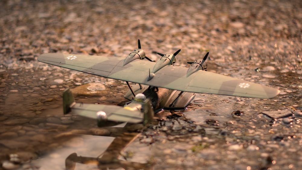 a model airplane sitting on top of a puddle of water