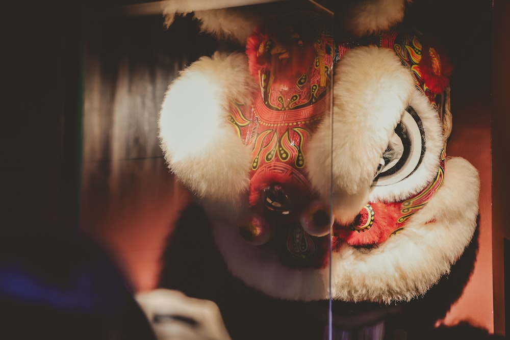 a stuffed animal wearing a red and white mask