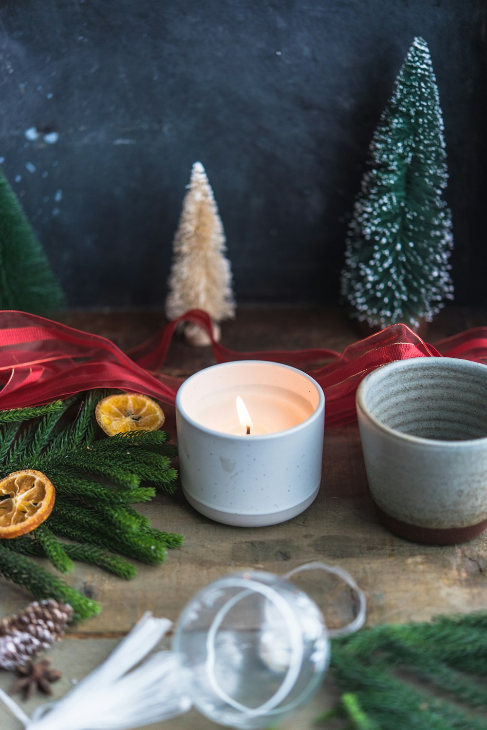 a white candle sitting on top of a wooden table