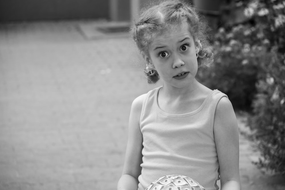 a little girl with a surprised look on her face