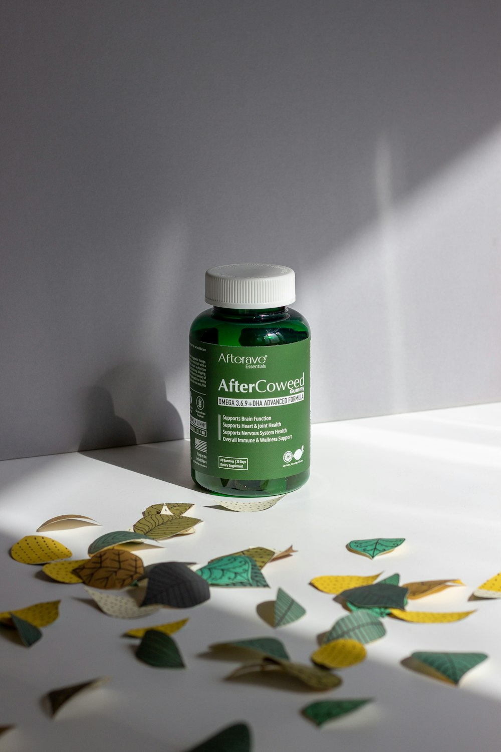 a bottle of green liquid sitting on top of a table