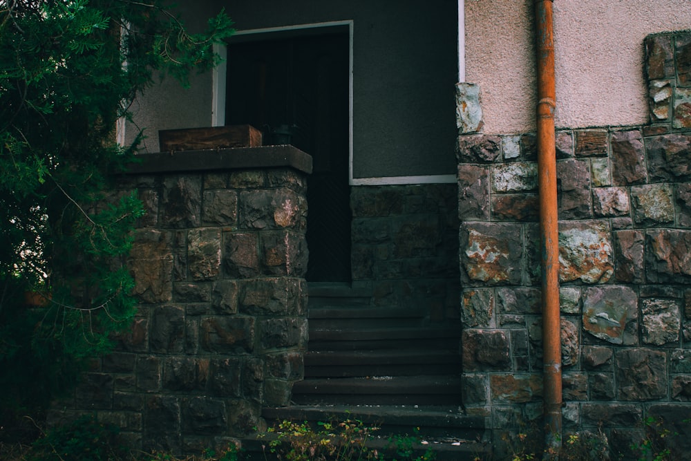 a stone building with a door and steps leading up to it