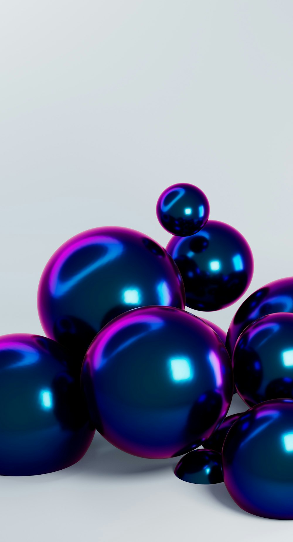 a pile of shiny blue balls sitting on top of each other