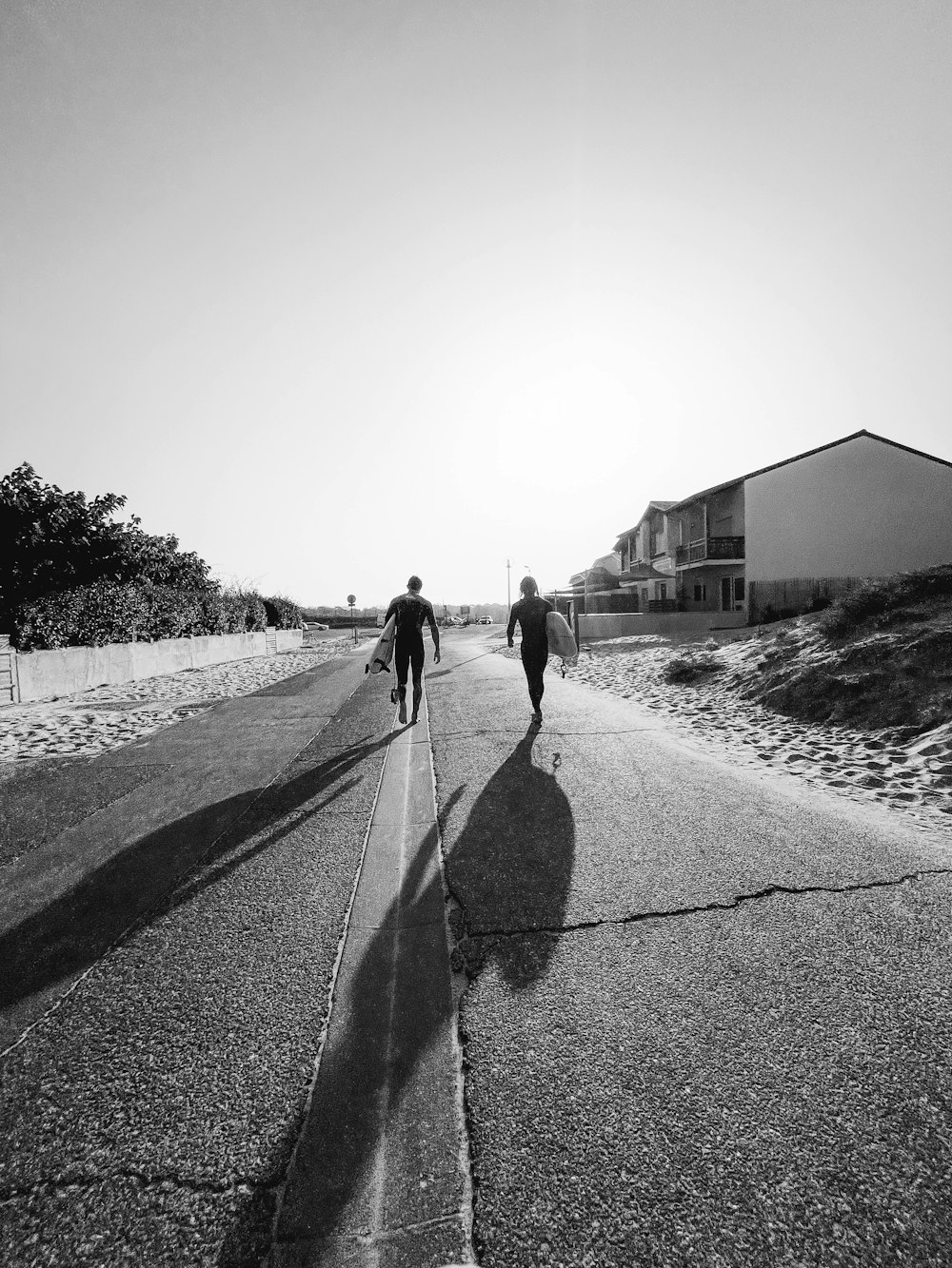 a couple of people walking down a street