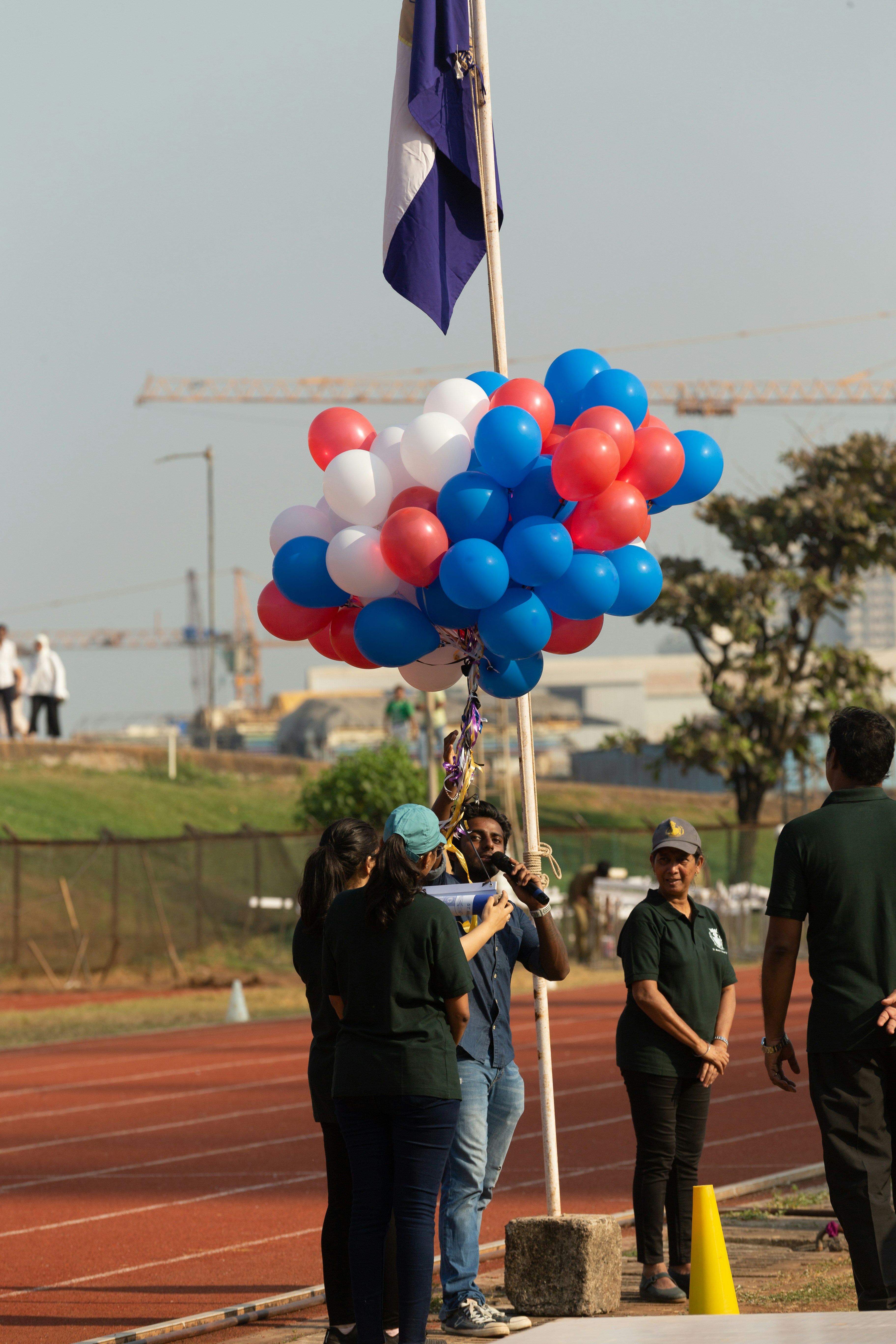 a group of people standing around a flag pole