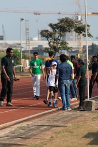 a group of people standing on top of a track