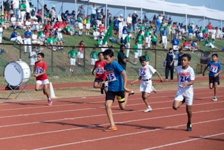 a group of kids running on a track