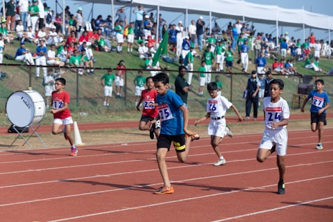 a group of kids running on a track