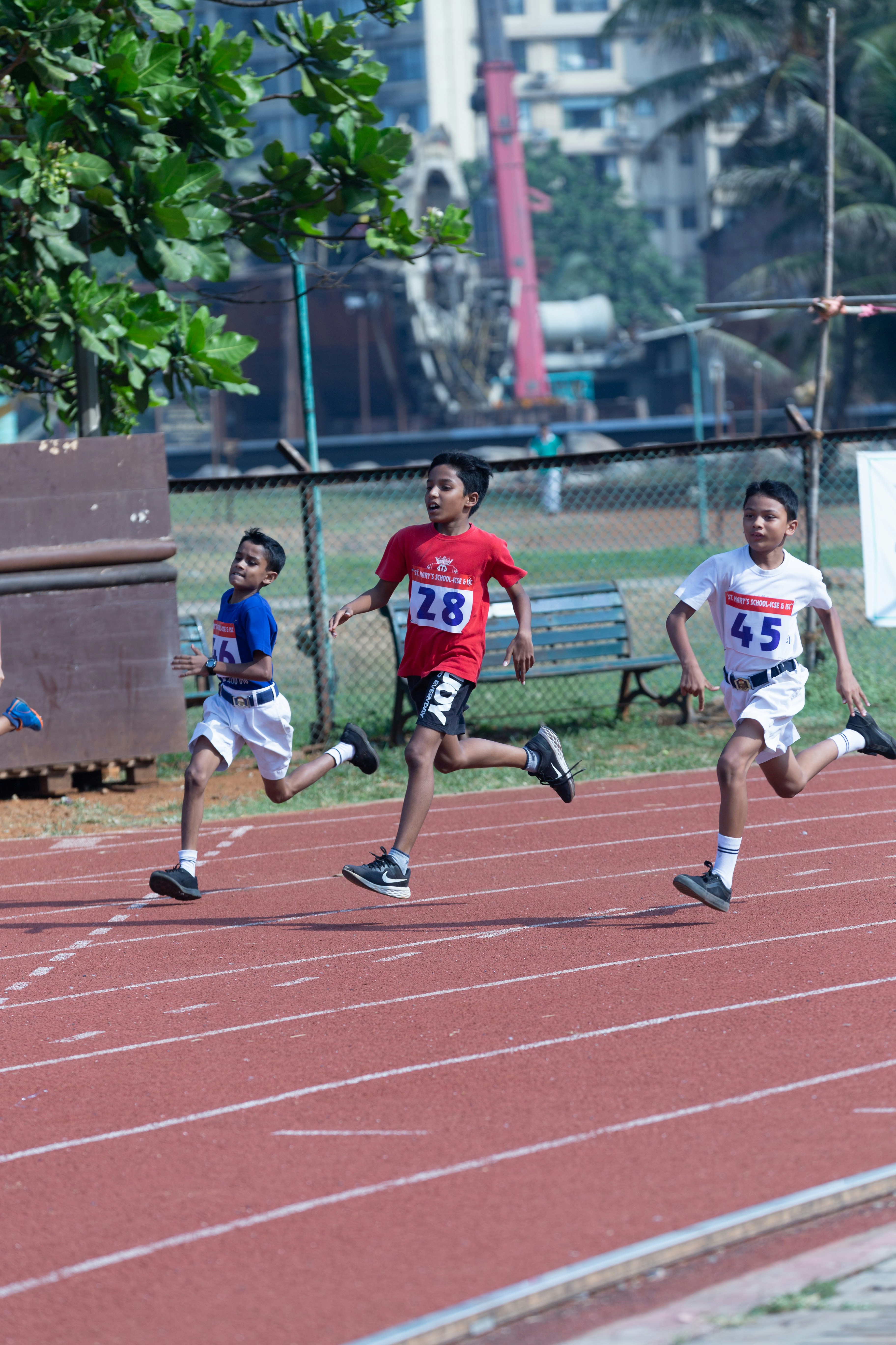 a group of kids running on a track