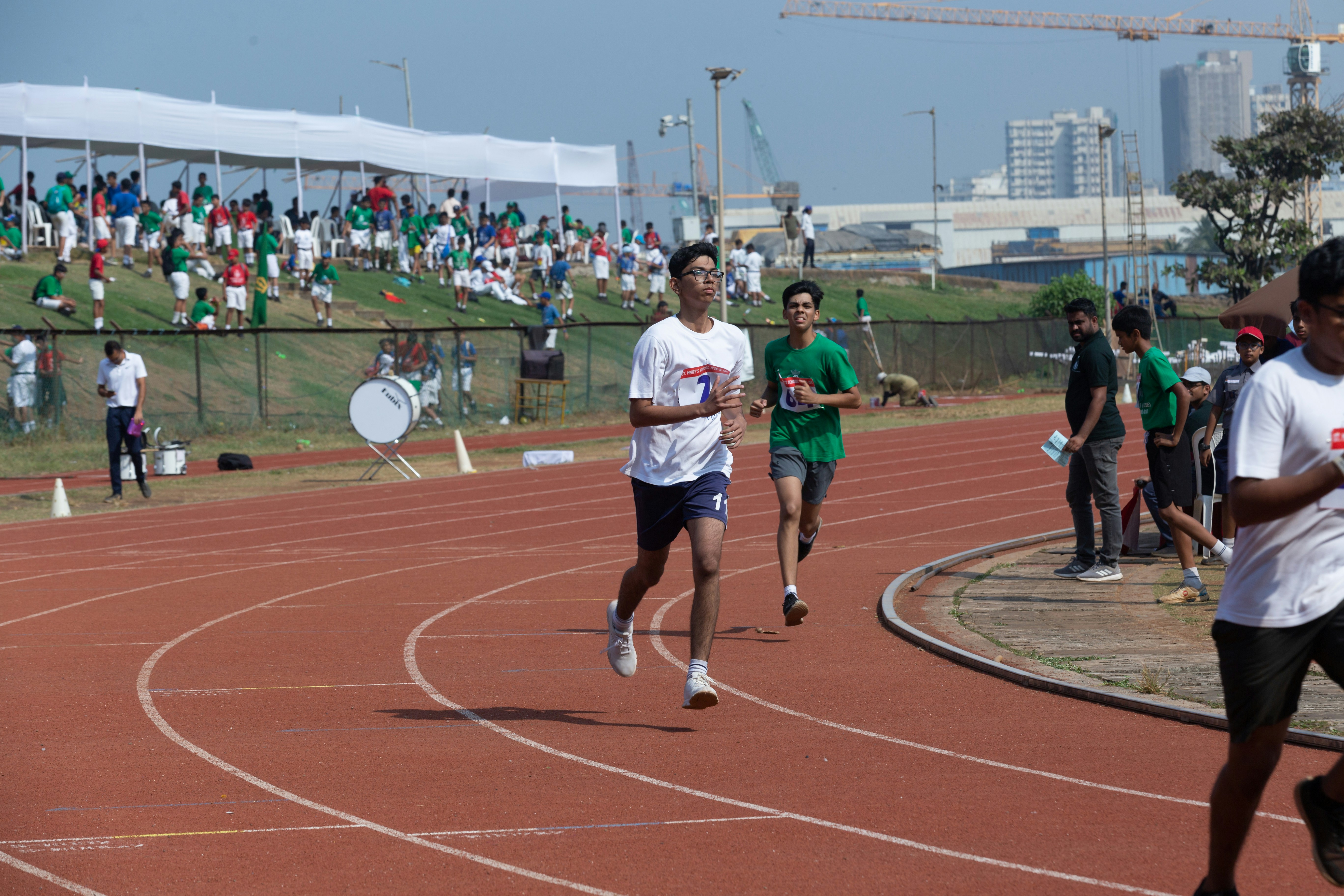 Group of people running on a track