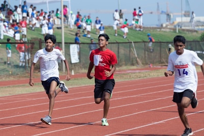 Athletes sprinting fiercely on a track during a sunny day