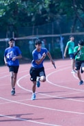 Smiling group of young runners celebrating a completed relay race.