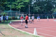 A group of kids competing happily in a mini obstacle race with bright cones and playful challenges.