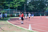 Kids lined up ready for a fun relay race with soccer balls.