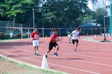 a group of young men running around a track