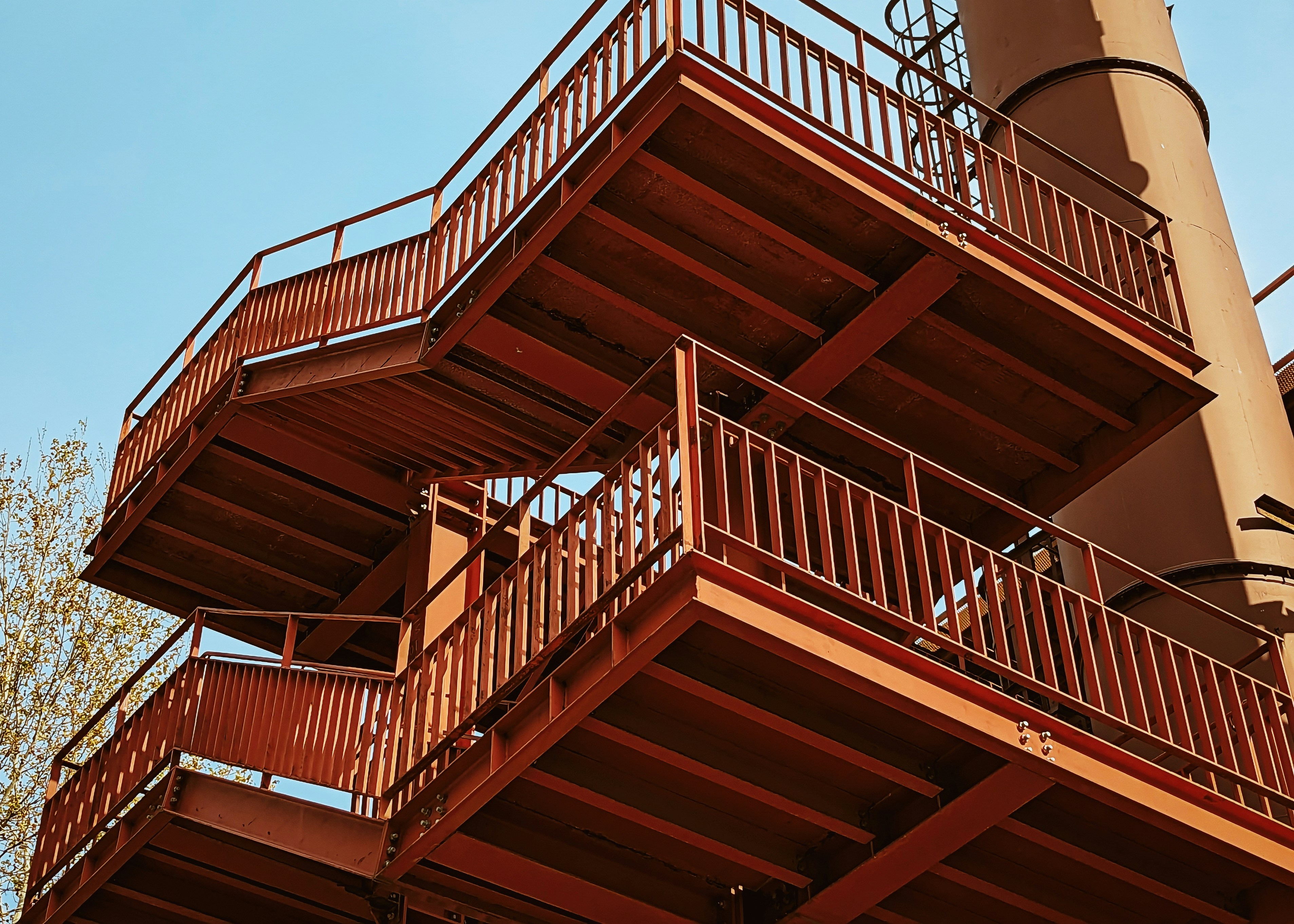 a tall red building with lots of balconies