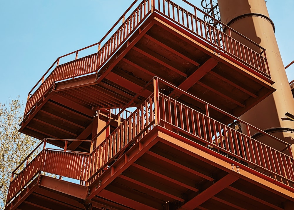 a tall red building with lots of balconies