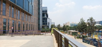 A modern office building in an urban setting with people walking nearby.