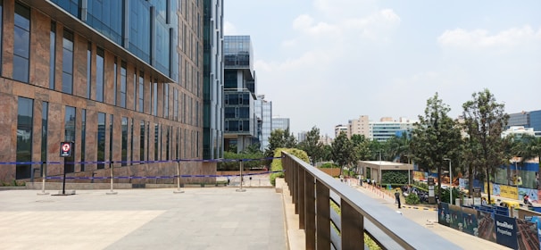 A modern office building in an urban setting with people walking nearby.
