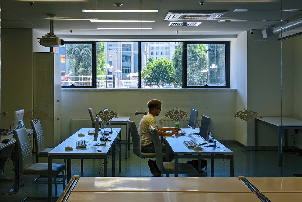 a man sitting at a desk in an office