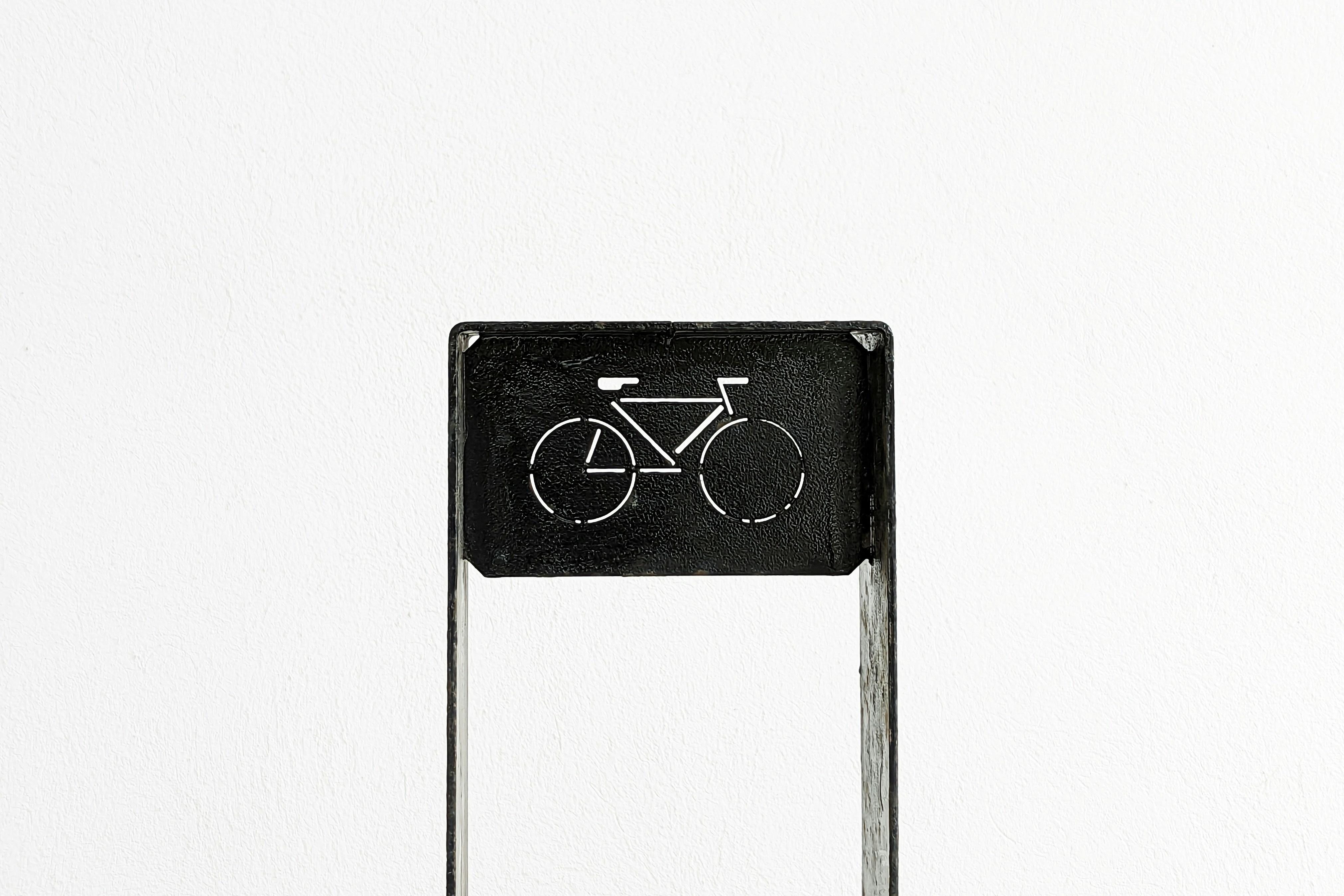 a black and white photo of a sign with a bicycle on it