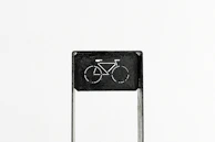 A minimalist buchtriders enamel pin displayed on a black denim vest.