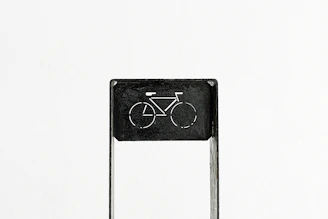 A minimalist buchtriders enamel pin displayed on a black denim vest.
