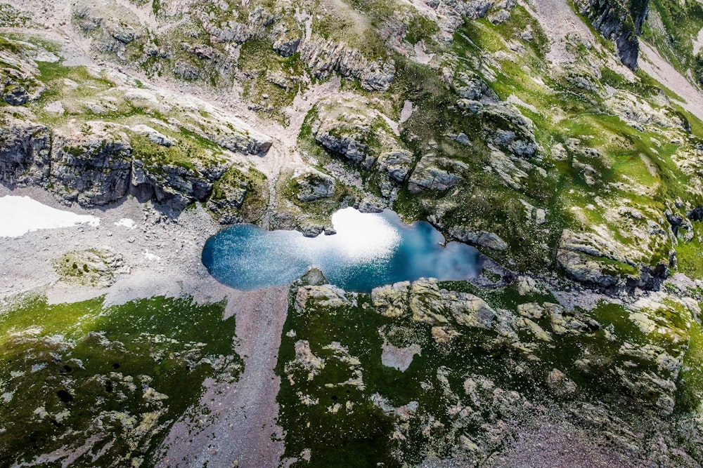 an aerial view of a lake in the mountains