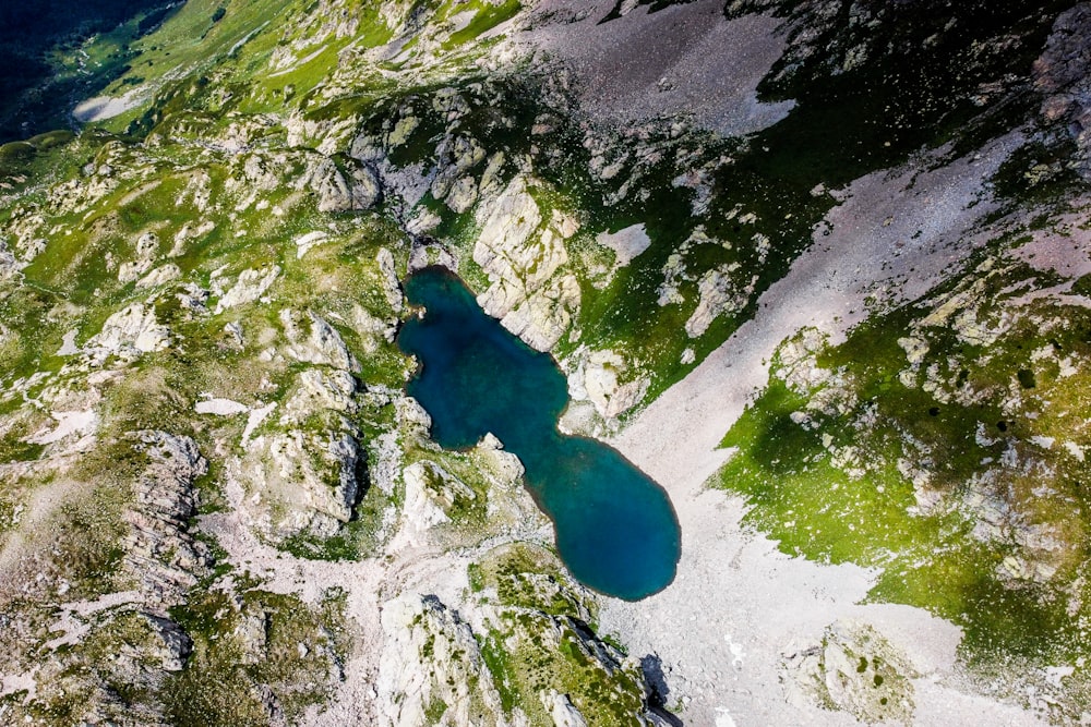 a view from a plane of a lake in the mountains