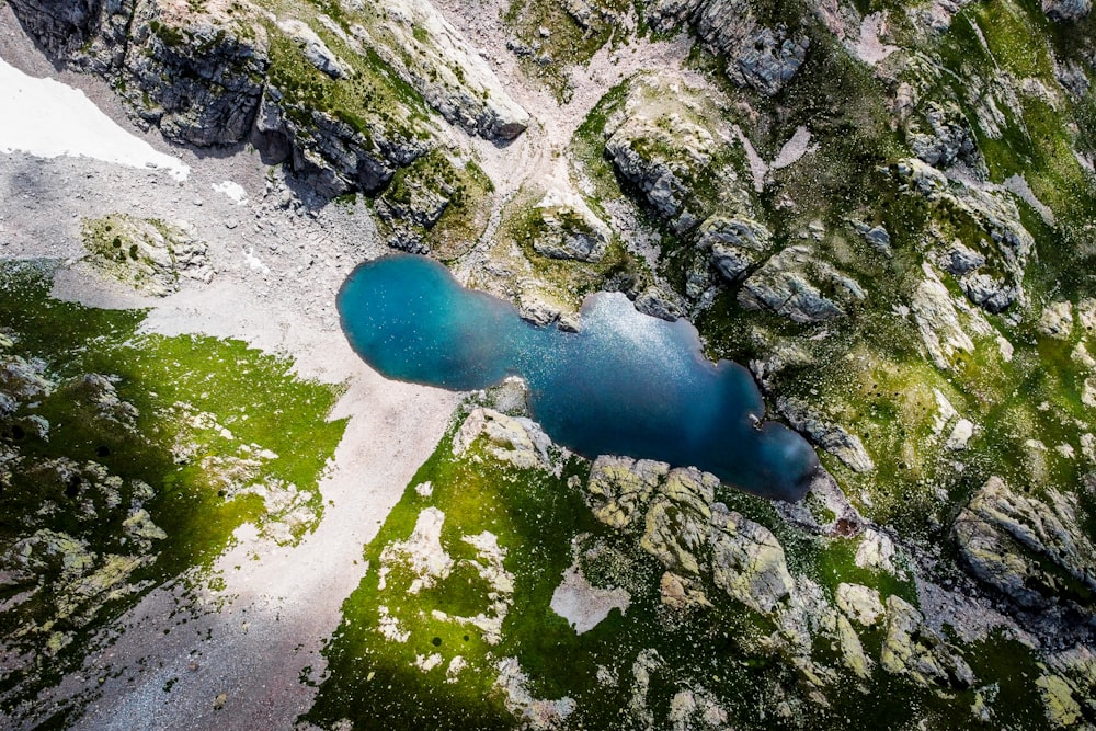 an aerial view of a lake surrounded by rocky terrain