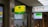 A Cathay United Bank ATM sign is prominently displayed with a yellow and green color scheme. It is located next to a FamilyMart convenience store sign. The setting appears to be indoors with visible elements of a commercial or shopping space, including signage with Chinese and English text.