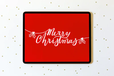 A tablet screen featuring a colorful XV años party invitation with festive design.