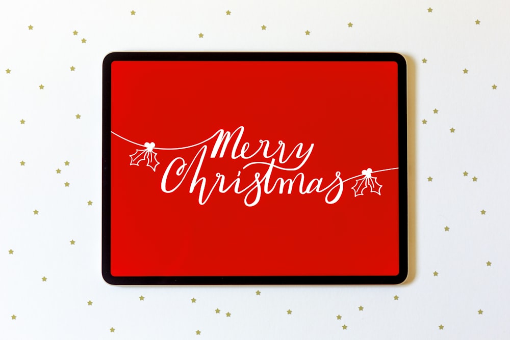 a red christmas card with white lettering on it