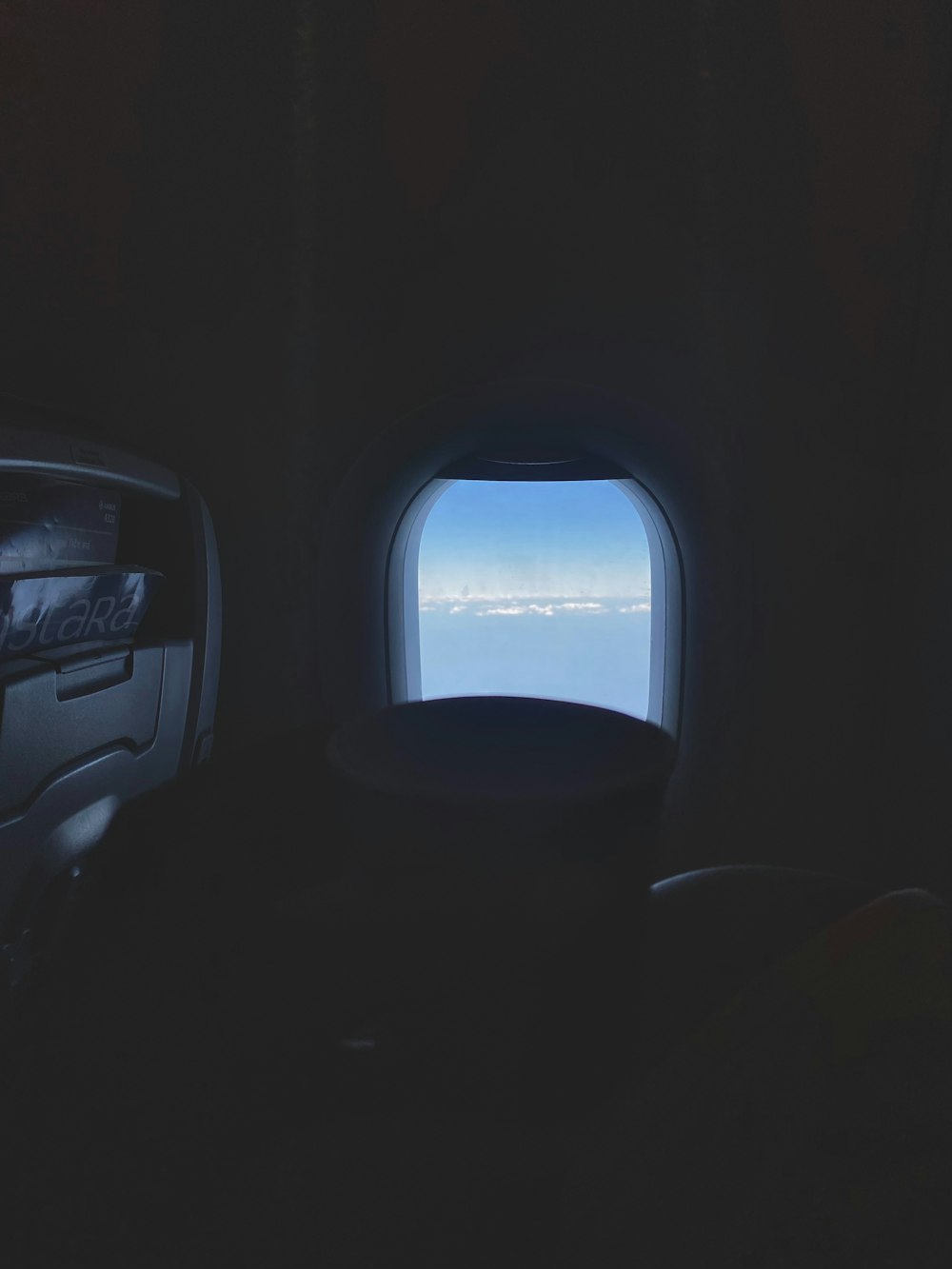 an airplane window with a view of the sky