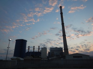 Wide shot of a large-scale scaffolding structure surrounding an industrial plant at dusk.