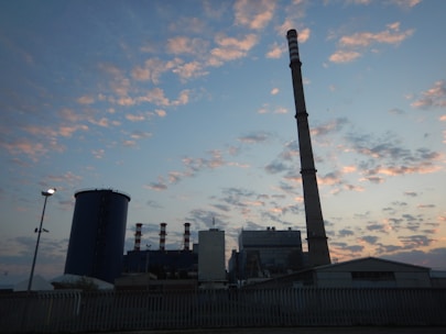 Wide shot of a large-scale scaffolding structure surrounding an industrial plant at dusk.