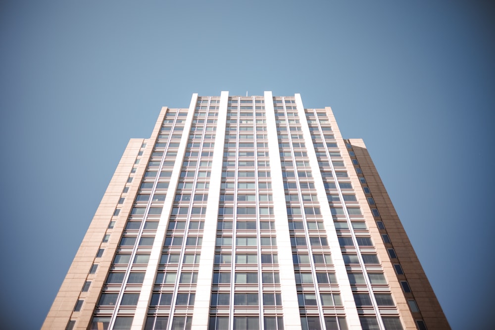 a tall building with lots of windows against a blue sky