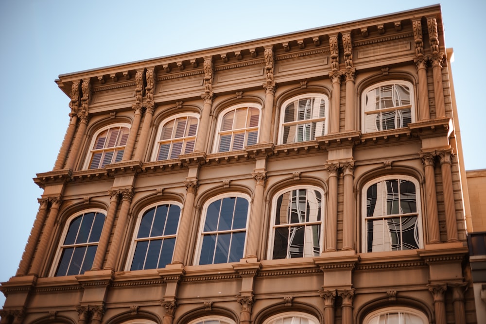 a building with many windows and a clock on the side of it