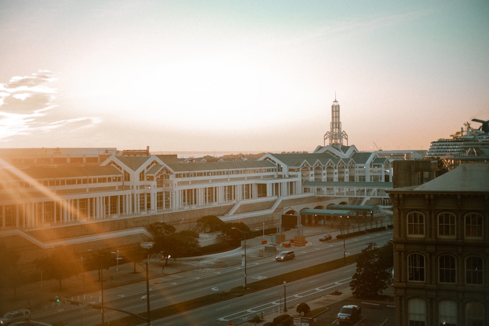 the sun is setting over a city street