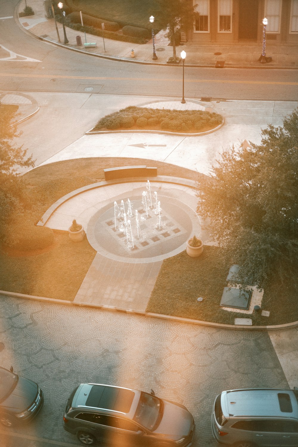 an aerial view of a park with a fountain