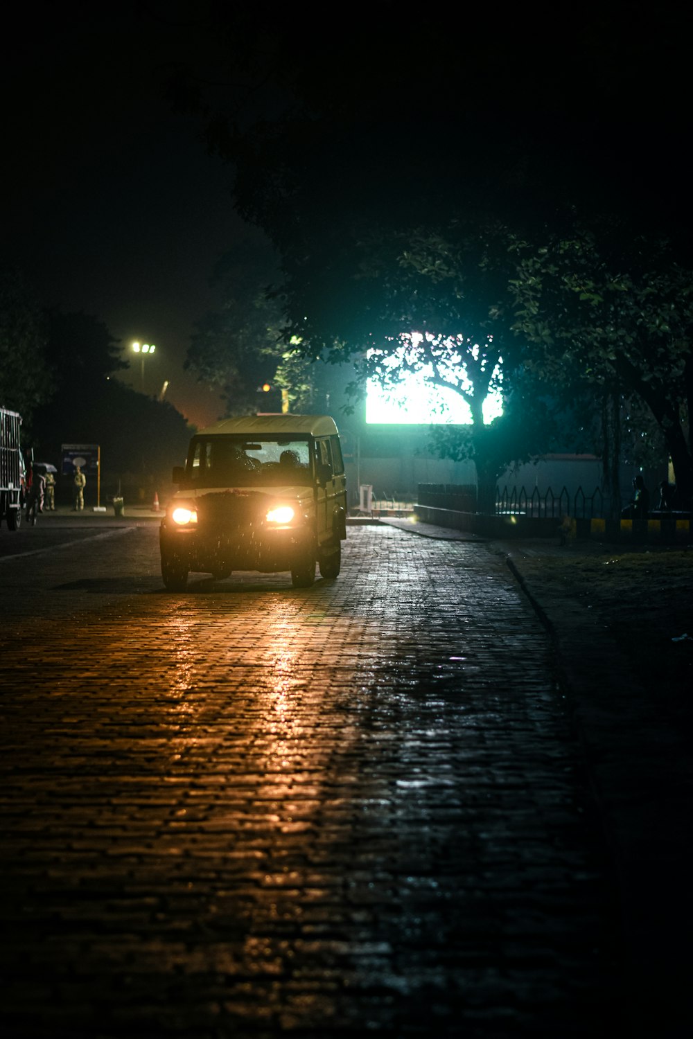 a car driving down a street at night