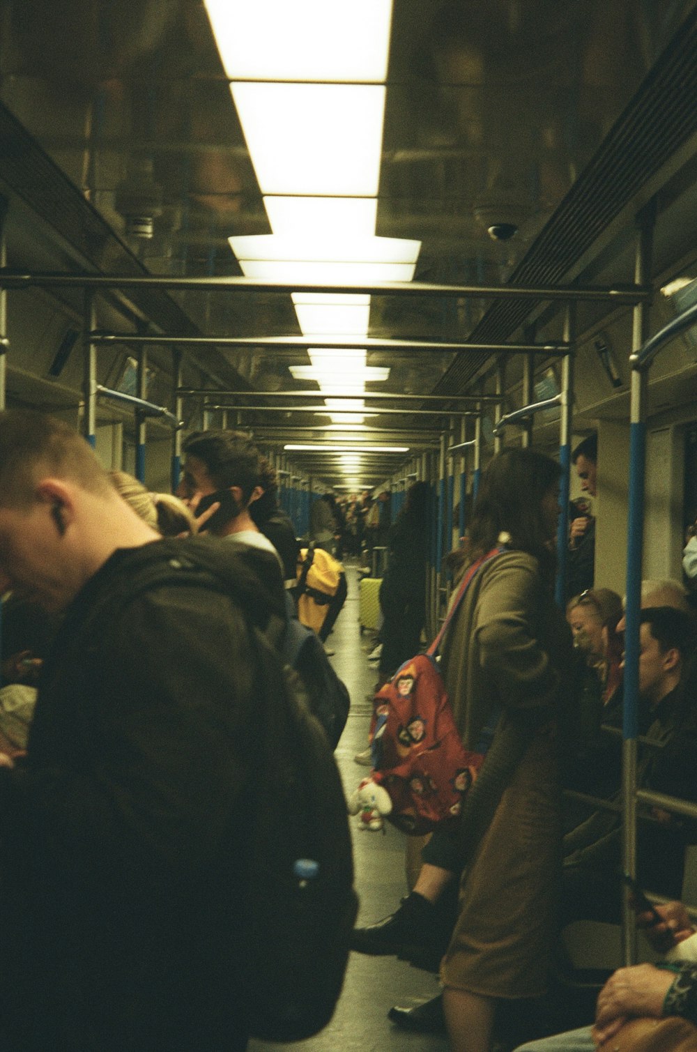 a group of people sitting on a train next to each other