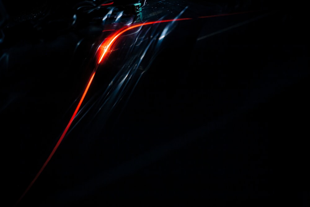 a blurry photo of a car driving in the dark