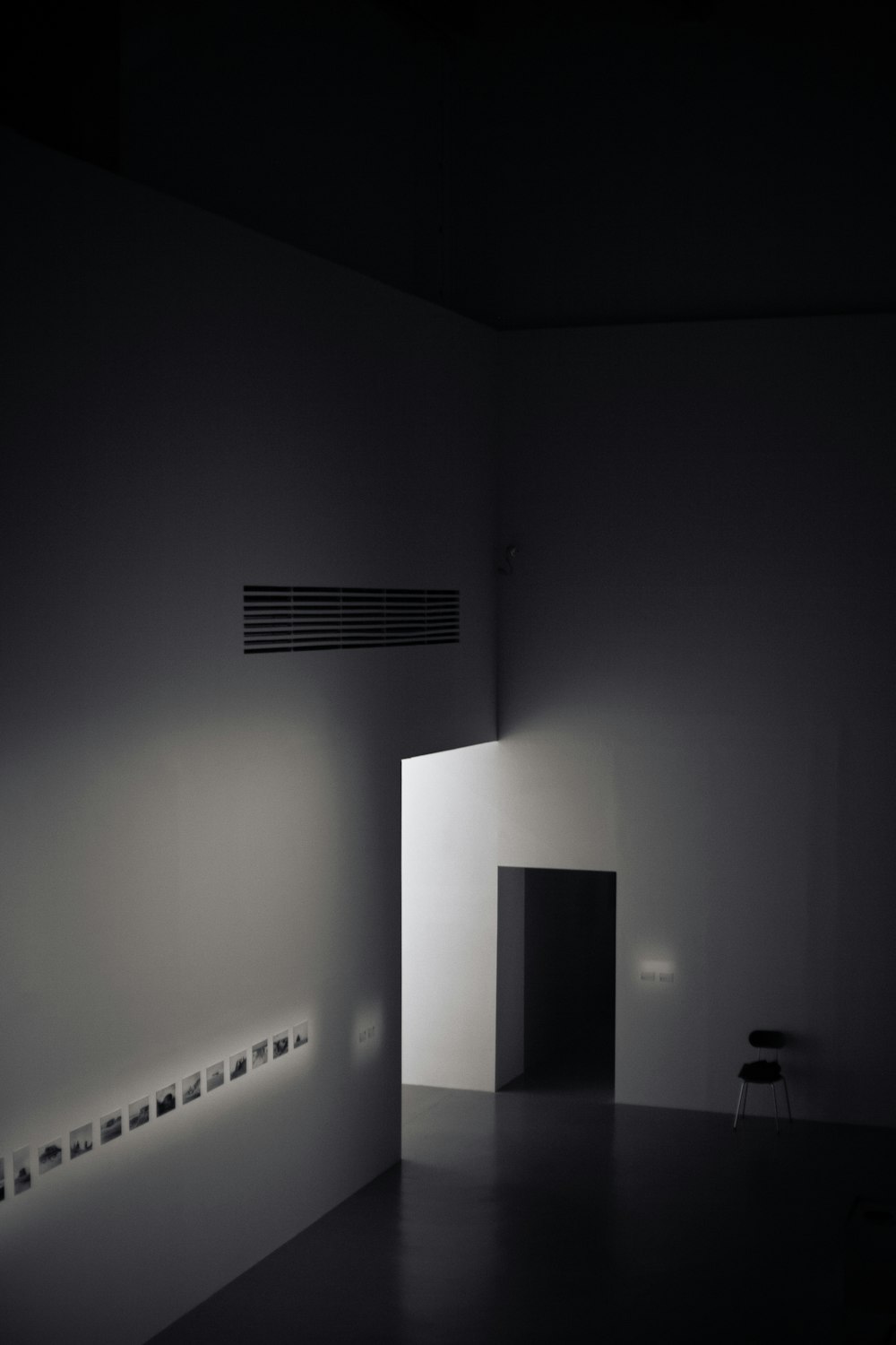 a dimly lit room with a light coming through the door