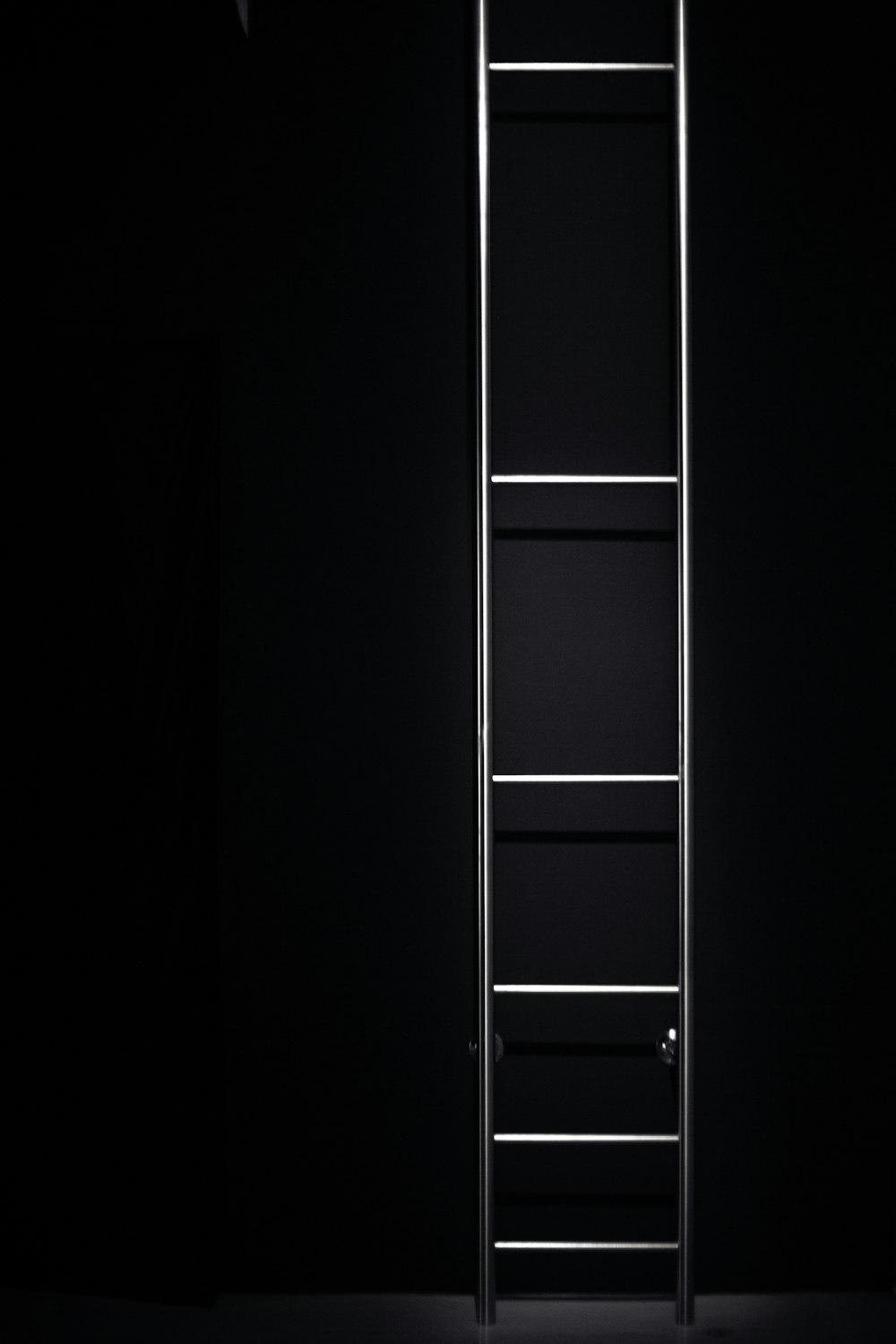 a ladder is lit up in the dark