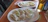 A couple sharing a plate of dumplings in the warmly lit interior of Golden Ginger.