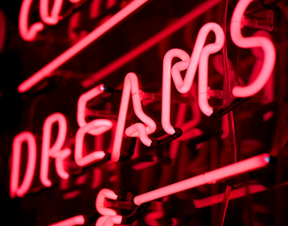 a close up of a neon sign on a wall