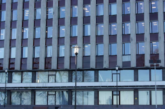 Commercial building facade with glass windows and street view.